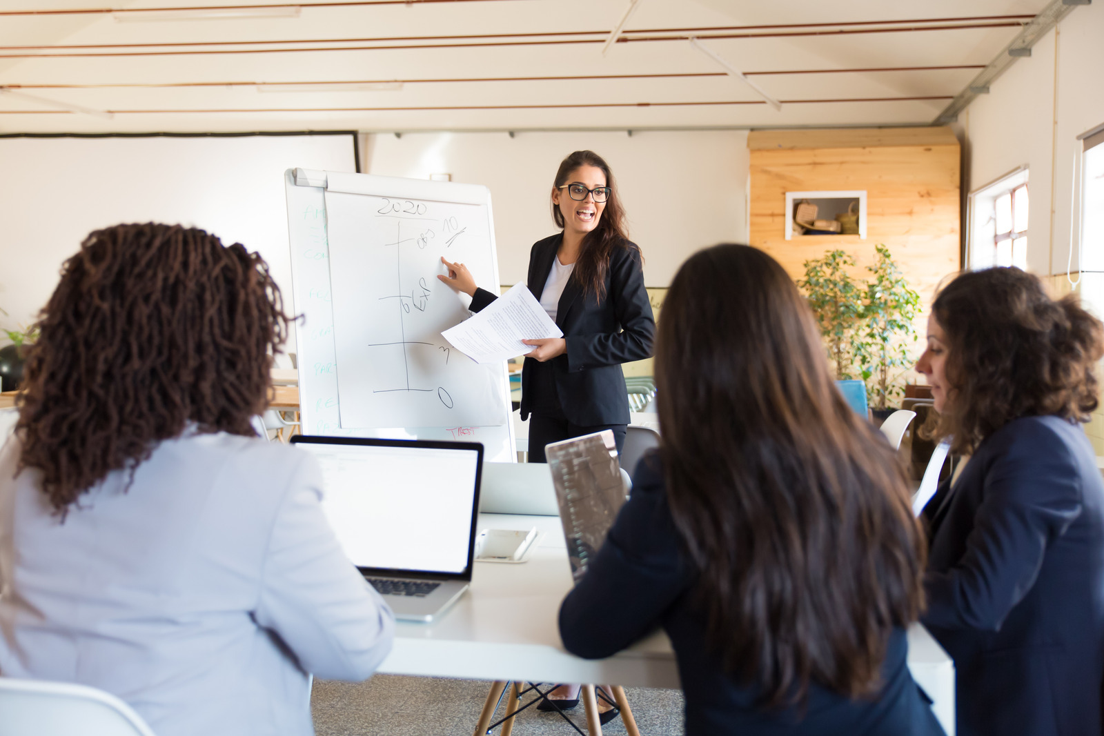 Business coach standing near whiteboard